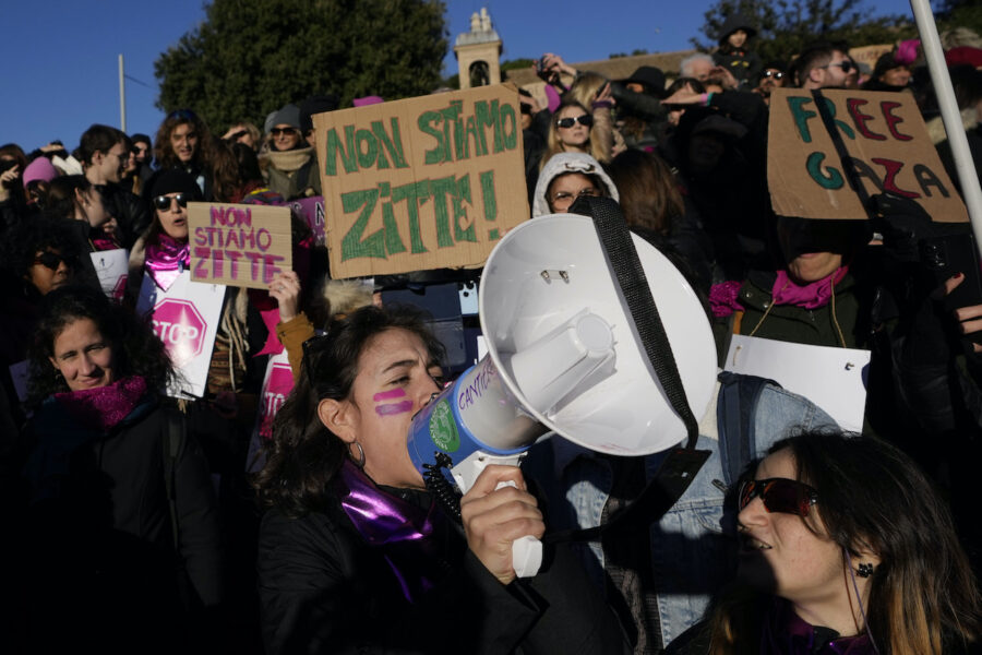 Demonstranter mot våld mot kvinnor i Italien. En kvinna håller en megafon