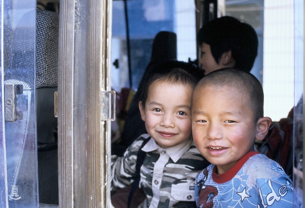 Två små barn tittar in i kameran.